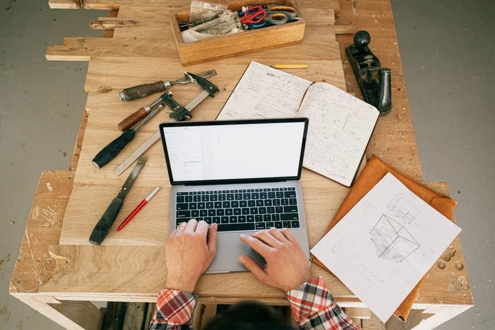 A tradesperson trying the demo on a laptop at his workbench